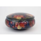 WILLIAM MOORCROFT A leaves and berries powder pot and cover, 15cm diameter, with impressed and