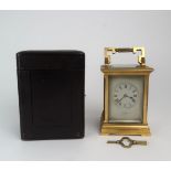 A 19TH CENTURY FRENCH BRASS AND GLASS CARRIAGE CLOCK with silvered dial, and roman numerals,
