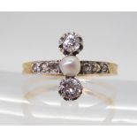 A VINTAGE DIAMOND & PEARL RING the twin diamonds are estimated approx 0.30cts combined, with further