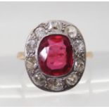 A VINTAGE RED GEM & DIAMOND RING the ring is mounted in yellow and white metal and set with a