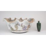 A LARGE KUTANI BASIN  The everted wavy rim above a frieze of figures at various pastimes ,20cm high,