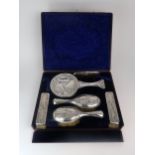 KATE HARRIS FOR WILLIAM HUTTON & SONS; a cased six piece Art Nouveau silver dressing table set,