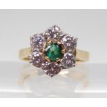 AN 18CT GOLD FLOWER RING set with estimated approx 0.90cts of brilliant cut diamonds surrounding a