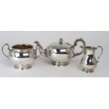 AN EDWARDIAN SILVER BACHELORS TEA SERVICE by Martin, Hall & Co, Sheffield 1902, of globular form,