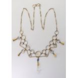 A MOONSTONE DROP NECKLACE mounted throughout in yellow metal, with spectacle set moonstones and a