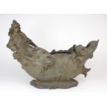 A SPELTER JARDINIERE moulded with a reclining maiden amongst waves with a fish to the other end,