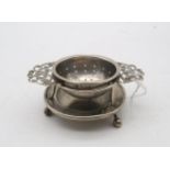 An Edwardian silver tea strainer and stand, by Harrison Brothers & Howson, Sheffield 1911, the
