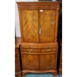 A 20th century walnut veneered serpentine front drinks cabinet with pair of cabinet doors concealing