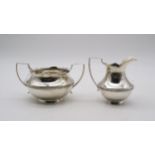A silver cream jug and sugar bowl, by Wilmot Manufacturing Co, Birmingham 1927, with banded floral