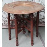 A 20th century Moorish style circular brass topped table on folding base with masharabiya panels,