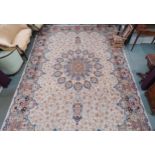 A beige floral patterned ground Tabriz rug with multicoloured central medallion and matching