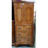 A 20th century mahogany bow front drinks cabinet with pair of cabinet doors concealing fitted