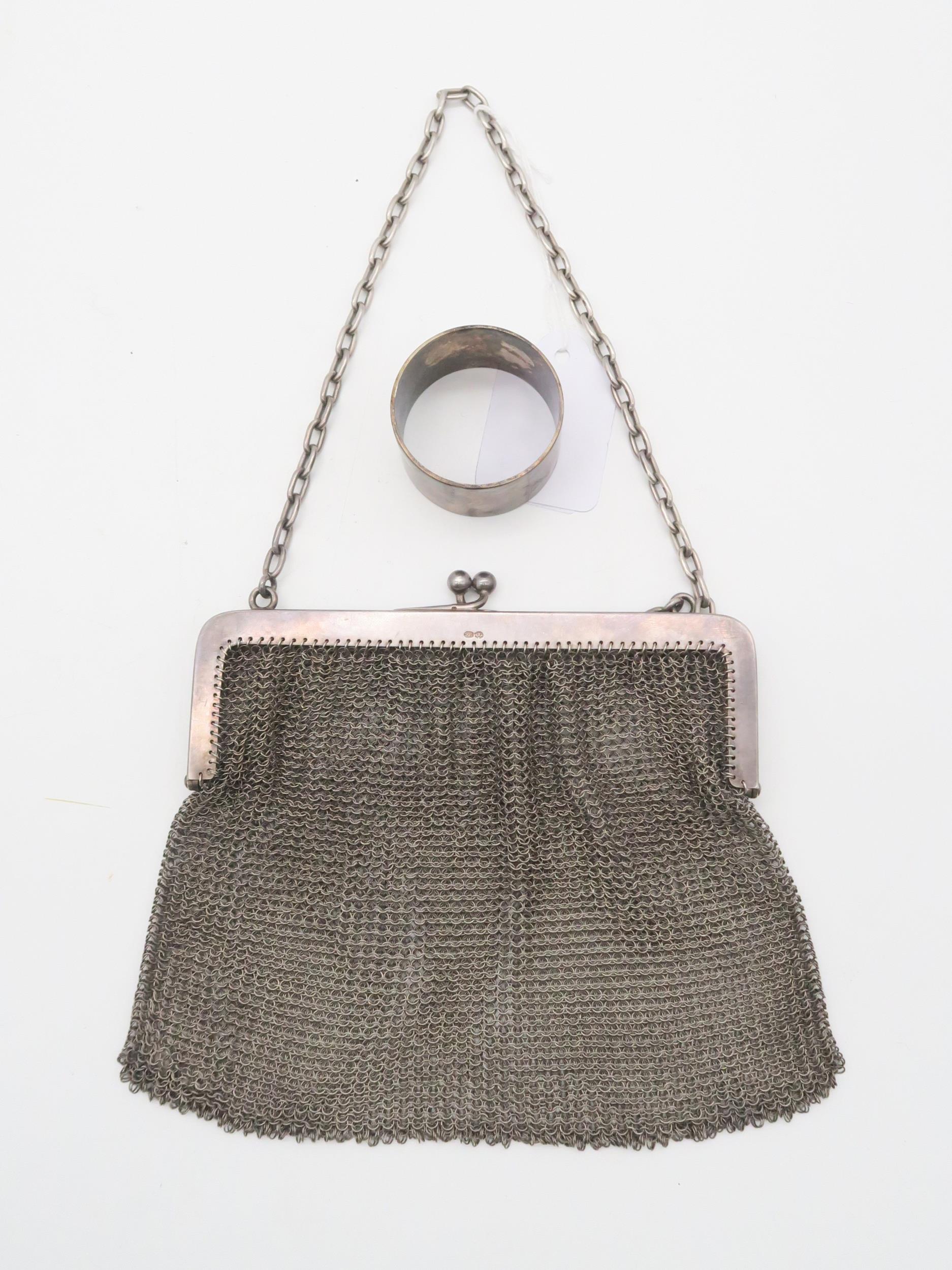 A silver chain mesh purse, with import marks for Paul Ettinger, London, and an EPNS napkin ring (