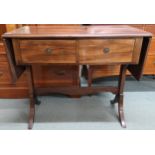 An early 20th century rosewood drop end sofa table with two drawers on out-swept supports joined