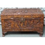 A 20th century Oriental carved camphorwood chest with internal tray on clawed feet, 51cm high x 93cm