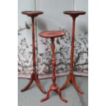A pair of mahogany circular topped jardinière stands 100cm high and another shorted Jardinière stand