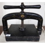 A 19th century black and mottled gilt painted cast iron hand cranked book press, 33cm high x 41cm