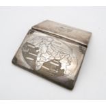 An Indian white metal cigarette case, engraved with the Taj Mahal, the reverse with a map, with