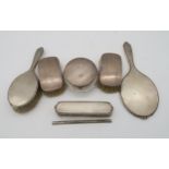 A collection of silver dressing table set items, a three piece set by Adie Brothers Ltd, Birmingham,
