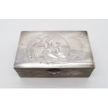 An Indian white metal cigar box, of rectangular form, the lid decorated with a maiden holding a