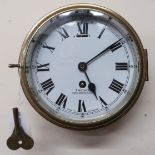 An early 20th century brass cased Smith's Cricklewood. N.W.2 bulkhead clock with white enamelled