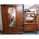 An Edwardian mahogany bedroom suite comprising mirror doored wardrobe, 205cm high x 144cm wide x