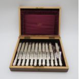 A cased set of silver bladed and mother of pearl handled fish knives and forks, (one knife and