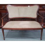An Edwardian mahogany framed parlour settee with green velour upholstered backrest and seat on