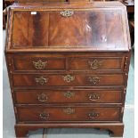 A 19th century walnut veneered writing bureau with fall front fitted writing compartment over two