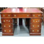 A 20th century campaign style pedestal writing desk with embossed skiver over three drawers on three