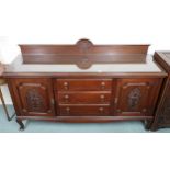 A 20th century mahogany sideboard with three central drawers flanked by cabinet doors on cabriole
