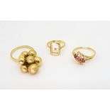 Three 18ct gold rings, a buckle ring, size H1/2, bobbles ring, size O1/2, and a ruby and diamond