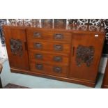 A 20th century Oriental hardwood sideboard with four central drawers flanked by cabinet doors on