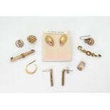 A collection of 9ct gold and yellow metal to include two pairs of earrings, odd earrings a brooch