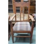 A late Victorian oak Arts & Crafts style open armchair with shaped top rail over inlaid rail back