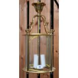 A 20th brass hallway lantern with four serpentine arms over cylindrical glass shade, 52cm high x