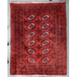 A red ground Bokhara rug with lozenge design and multiple borders, 140cm long x 109cm wide
