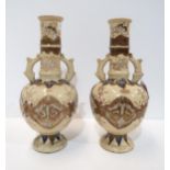 A pair of Japanese stoneware vases, of bottle form, decorated with birds and foliage, 31cm high (