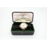 A 15ct gold cased ladies watch the case made by Saunders & Shepherd, with silk strap with 9ct gold