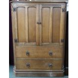 A 20th century AY Crown Furniture oak gents tall boy with pair of panel doors over two long