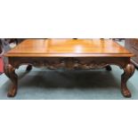 A 20th century mahogany coffee table with rectangular top on hairy paw feet joined by carved