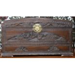 A 20th century Chinese camphorwood domed top blanket chest extensively carved with village scenes on