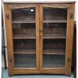 An early 20th century oak two door glazed bookcase, 124cm high x 107cm wide x 30cm deep Condition