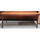 A mid 20th century teak coffee table with rectangular top on shaped tapering supports, 42cm high x