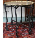 A 19th century brass topped folding table with scalloped edged top engraved with court scene on