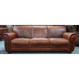 A contemporary Italian leather upholstered three seater sofa on turn feet, 85cm high x 233cm wide