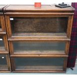 An early 20th century Globe Wernicke three tier sectional bookcase with glazed fall front doors,