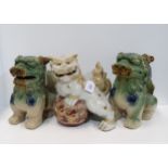 A pair of Chinese Sancai glazed fo dogs, and another white ground gilt decorated example (3)