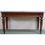 A contemporary reproduction mahogany hall table on turned supports, 81cm high x 152cm wide x 61cm