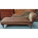 A Victorian mahogany chaise longue with velvet upholstery on turned supports terminating in